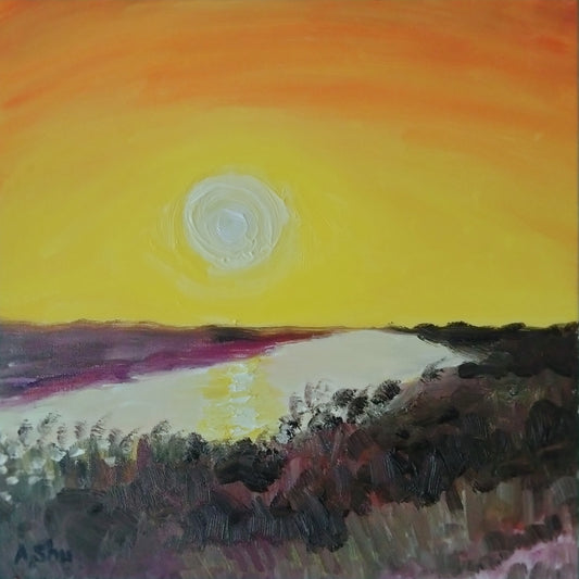 Sunset with bright orange and yellow sky reflecting in the Everglades waters in Florida