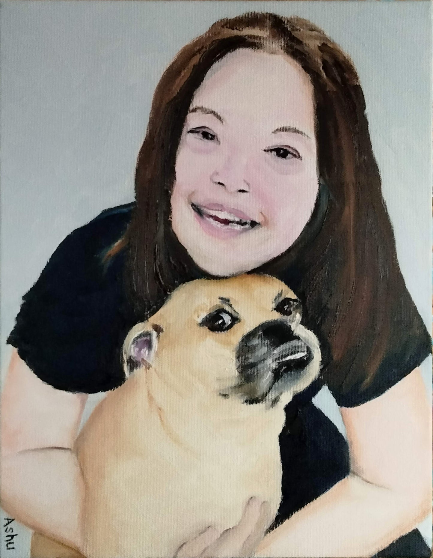 Portrait of a girl smiling and hugging a dog