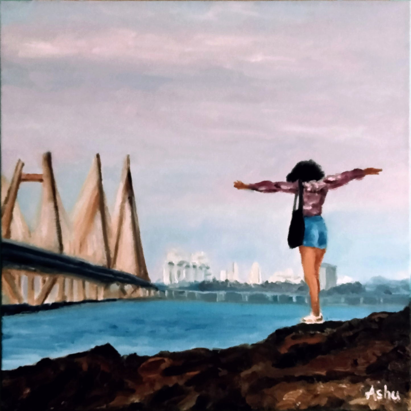 Woman standing on a rocky outcrop off the coast of megacity Mumbai, with her arms open, facing the iconic Worli-Bandra sea-link bridge and Bandra skyline across the deep blue Arabian Sea in the background